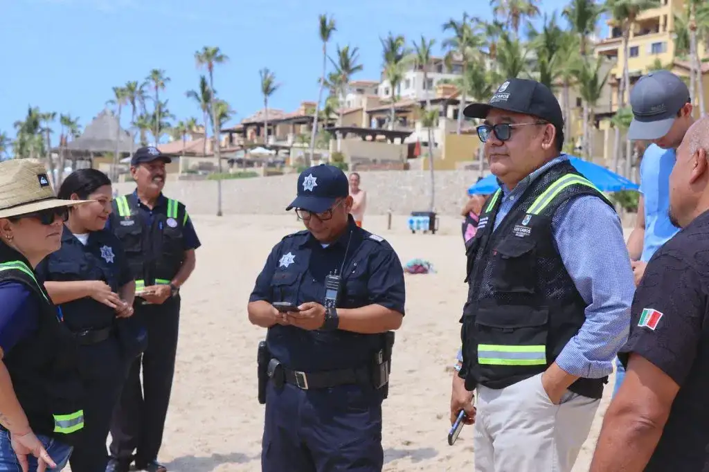 Vista de playa El Médano en Cabo San Lucas con bañistas y mobiliario