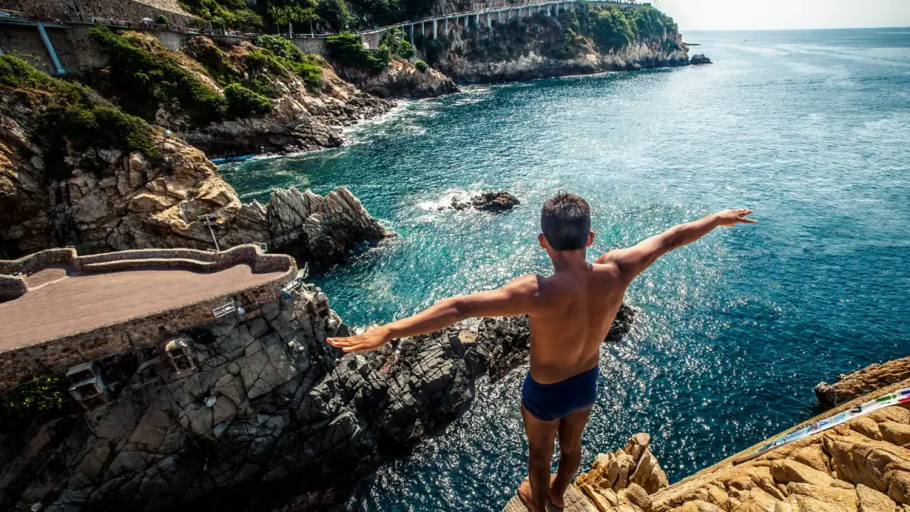 Clavadistas de La Quebrada durante un salto en el acantilado de Acapulco