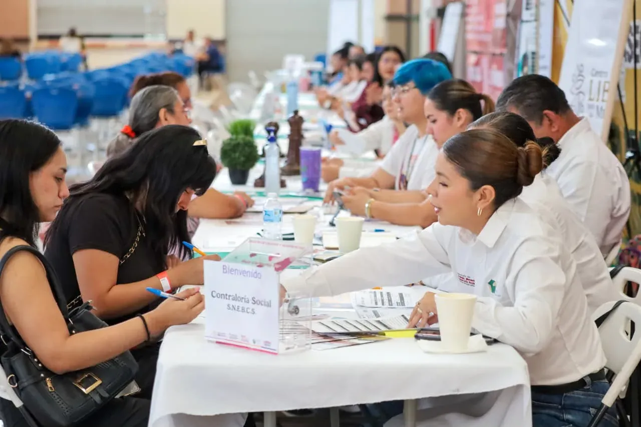 Personas en una feria de empleo revisando ofertas laborales