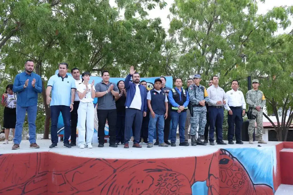 Personas pintando y limpiando un parque en Cabo San Lucas durante jornada de tequios