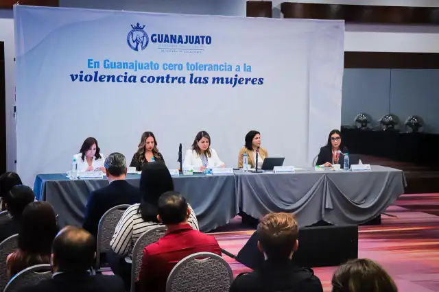 Mujeres caminando en una calle de Guanajuato con edificios gubernamentales de fondo